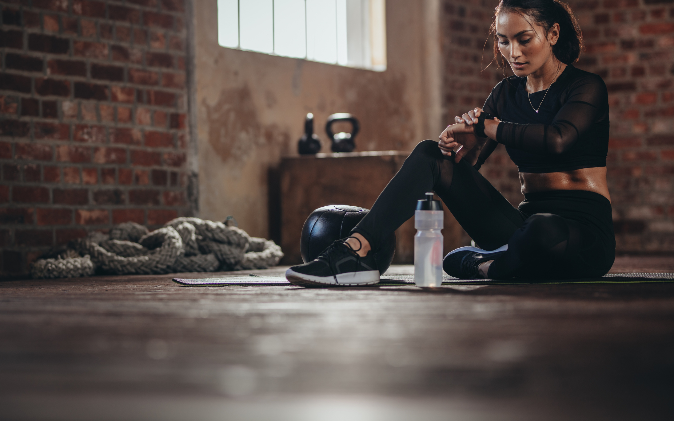 Woman Tracking Fitness Progress on Smart Phone
